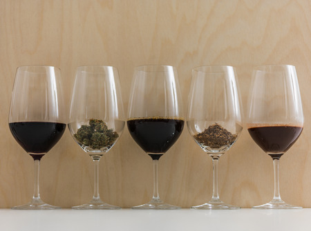 World's most popular addictions in wineglasses. Coffee, Chocolate, Wine, Cannabis, Tobaccoの写真素材