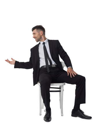 Businessman sitting on chair portrait isolated on white backgroundの写真素材