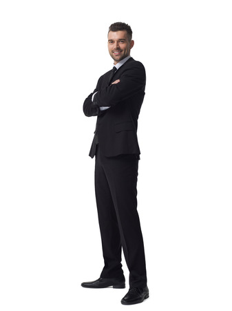 Businessman with folded hands full length portrait isolated on white backgroundの写真素材