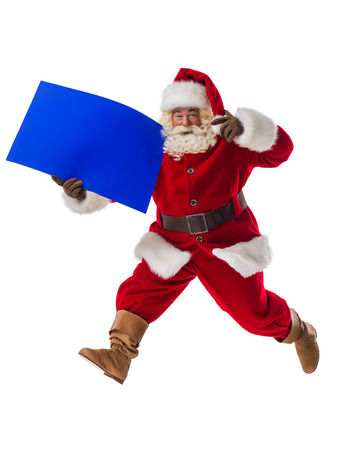 Santa Claus holding copyspace blank sign. Full Length Portrait Isolated on White Backgroundの写真素材