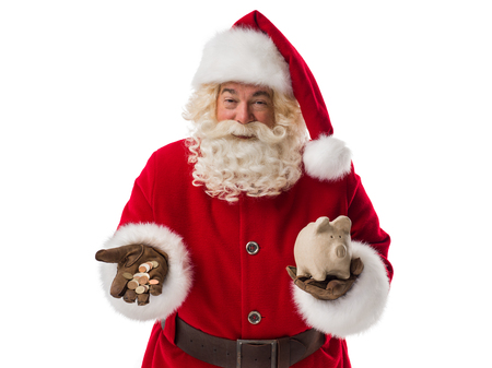 Santa Claus holding piggy bank and cash money. Portrait Isolated on White Backgroundの写真素材