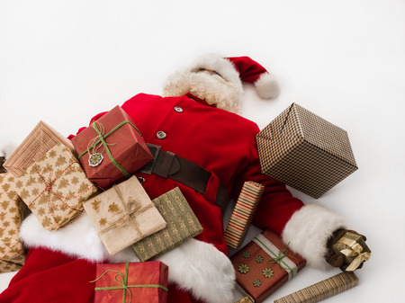 Santa Claus under stack of gift boxes Closeup Portraitの写真素材