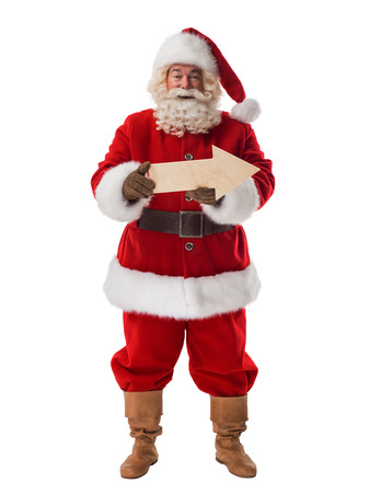 Santa Claus with wooden arrow that shows direction Full-Length Portraitの写真素材