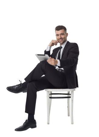 Businessman using tablet computer Full Length Portrait isolated on White Backgroundの写真素材