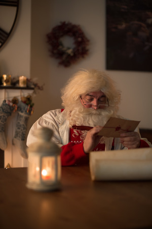 Santa Claus at Home writing and signing letter to child