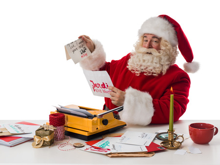 Santa Claus working with childrens letters Closeup Portrait Isolated on White Backgroundの写真素材
