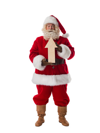 Santa Claus holding wooden arrow and showing direction Full Length Portrait isolated on White Backgroundの写真素材