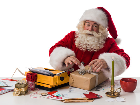 Santa Claus wrapping gift Closeup Portrait Isolated on White Backgroundの写真素材