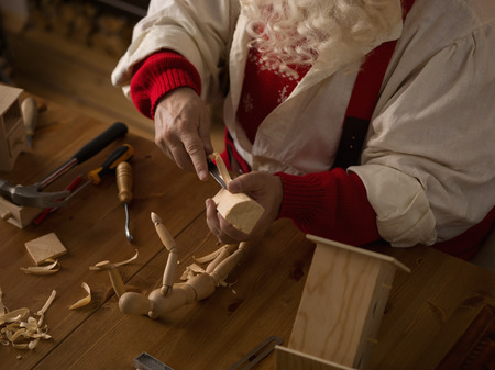Santa Claus Working at Home. Making Toys for Childrenの写真素材