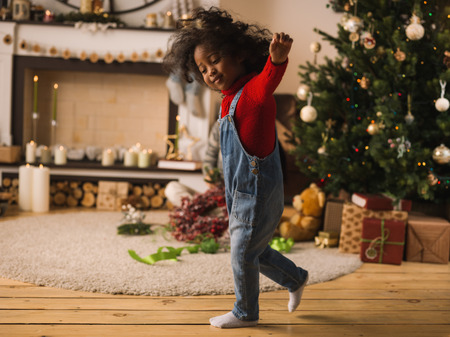 Little African Girl at Home with Christmas Interiorの写真素材