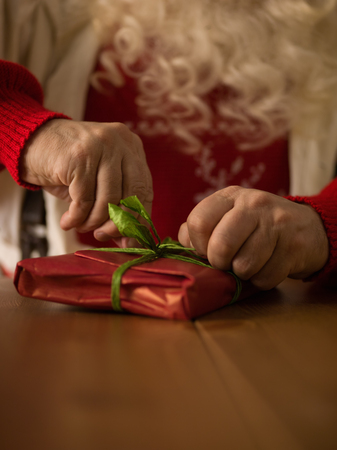 Santa Claus Working at Home. Wrapping Gifts for Childrenの写真素材
