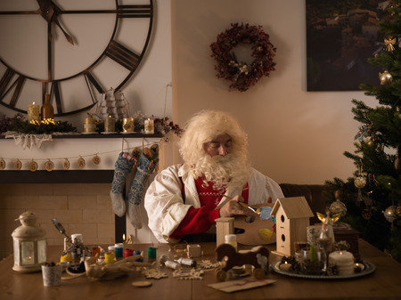 Santa Claus Working at Home. Making Toys for Childrenの写真素材