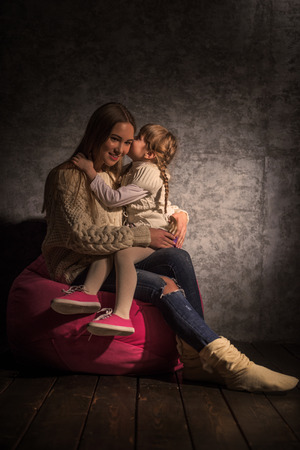 Sisters on Beanbag Hugging and having fun together at Homeの写真素材
