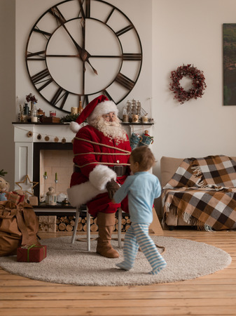 Santa Claus Playing at Home with Childの写真素材