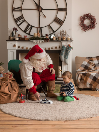 Santa Claus with Child Playing Together at Homeの写真素材