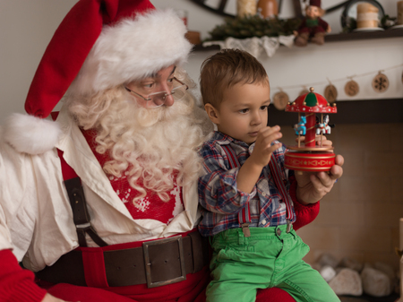 Santa Claus with Child Playing Together at Homeの写真素材