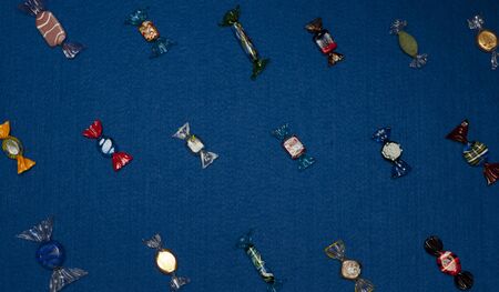 Glass handmade candies in blue backgroundの写真素材