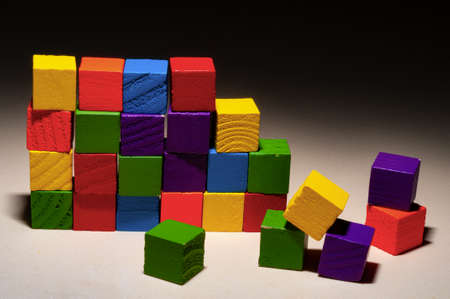 a wooden wall built by colorful bricks in the spotlight shotの写真素材