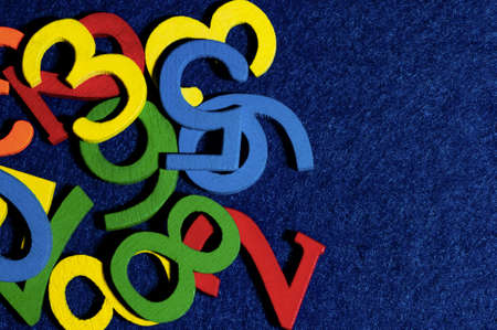 Colorful wooden letters on a blue background. The concept of education and learning.