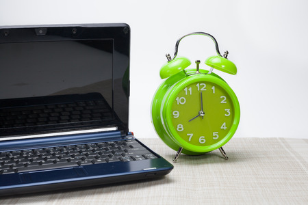 time concept-analog clock with laptopの写真素材