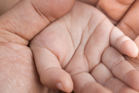 Adult hand holding kid handの写真素材