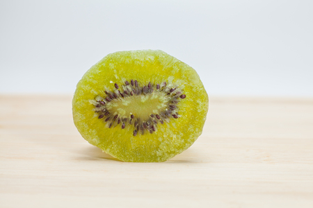 Dried kiwi on wooden over white backgroundの写真素材
