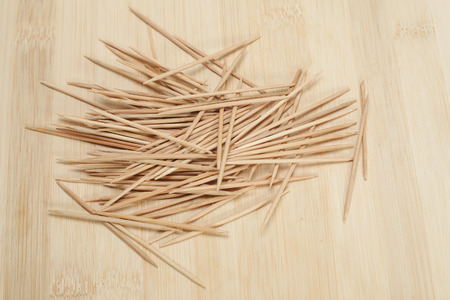 many wooden toothpicks on wooden table backgroundの写真素材