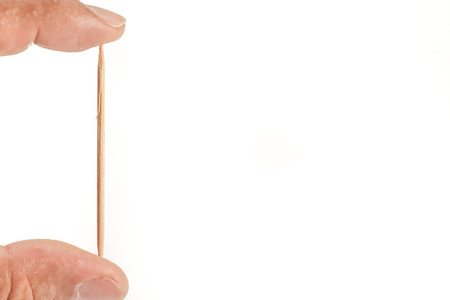 hand pick one wooden toothpicks over white backgroundの写真素材