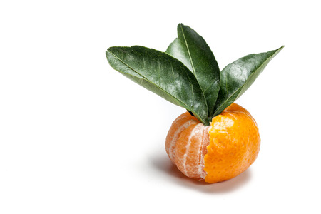 half peeled mandarins or tangerines with leaf isolated on white background.の写真素材