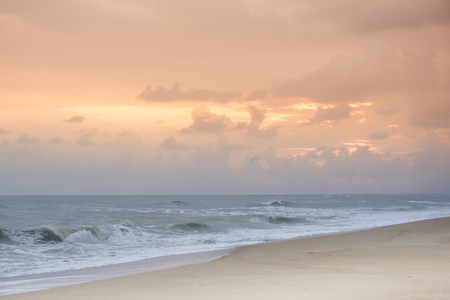 beach at sunset with cloudy skyの写真素材
