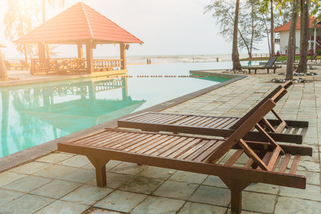 wooden swimming bench near the poolのeditorial素材
