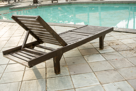 wooden swimming bench near the poolのeditorial素材