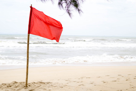 warning sign of a red flag at the beach