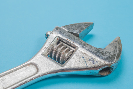 Adjustable wrench isolated on blue background