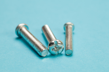 Assorted  screws close up  over blue background.の写真素材