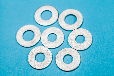 metal screw washers  on blue backgroundの写真素材