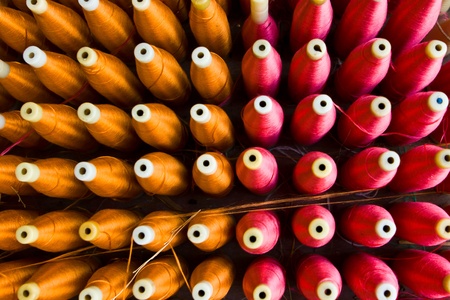 A background with the colorful of the cone threads from textileのeditorial素材