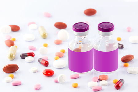 Injection vial and many kind of Medical pills isolated on white backgroundの写真素材