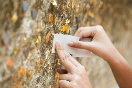 Thai tradition cover statue of Buddha with gold leaf and Hands were gildedの写真素材
