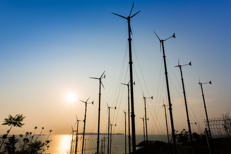 Silhouette windmills for electric power production at  Koh Larn ,Pattaya,Thailand
