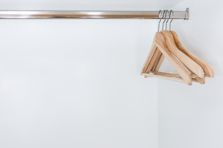 close up of Wooden clothes hanger in white wardrobeの写真素材