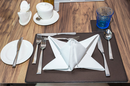 Empty glasses and plates set on the table in restaurantの写真素材