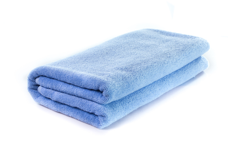Light Blue soft bath towel isolated on white backgroundの写真素材