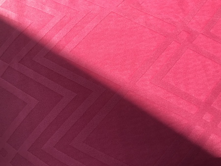 square pattern pink fabric and sun light shine half on it as diagonal, using for backgroundの写真素材