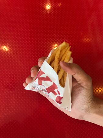 Phuket, Thailand - August 5, 2019: consumer nowaday is with french fries serving at KFC fast food restaurant, Phuket, Thailandのeditorial素材