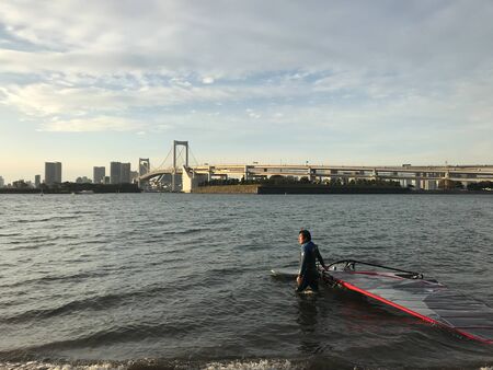 Tokyo, Japan %u2013 September 13, 2019: Japanese man were enjoying windsurfing alone in the sea at Odaiba, Tokyo, Japanのeditorial素材
