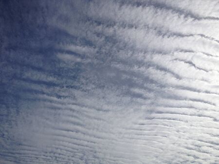 amazing clouds pattern look like tiger skin with bright blue sky, using for backgroundの写真素材