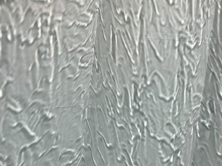 blurred shot of raining pour over clear glass window in full frame, using for backgroundの写真素材