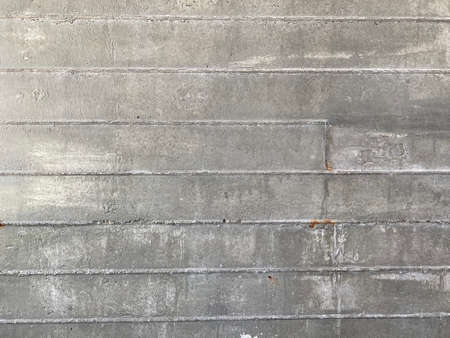 full frame shot of natural gray cement wall with rough lines, using for backgroundの写真素材