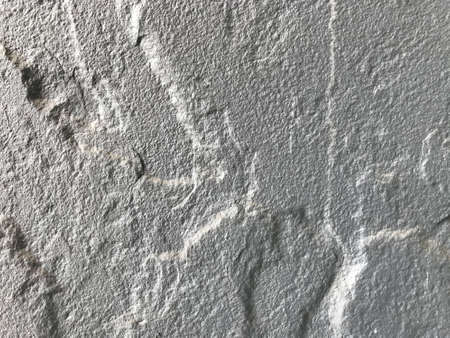 the rough texture of the gray cement wall looks like a silver metal plate in a full-frame shotの写真素材